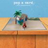 Exposed Open 3‑D camper van card, surfboard, palm and campfire on sandy beach