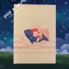 Soft pastel cover with baby riding whale illustration on new baby pop‑up card