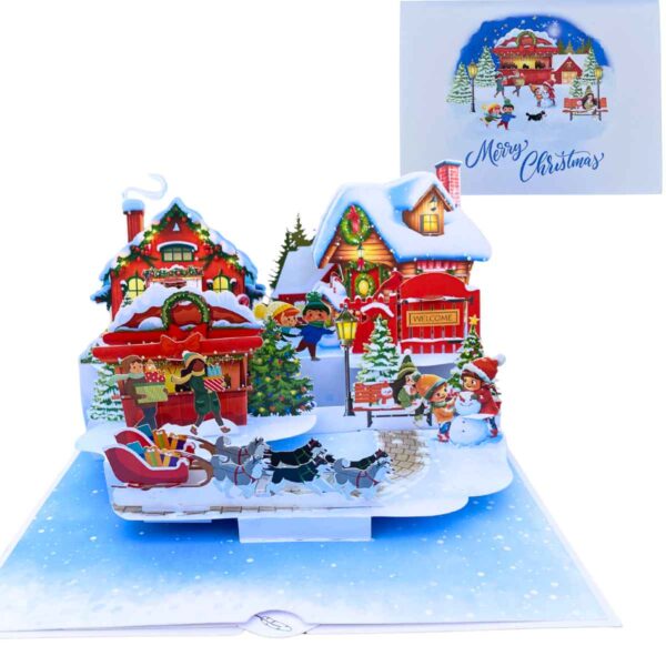 3D pop-up card of a snowy Christmas village displayed as a holiday decoration.