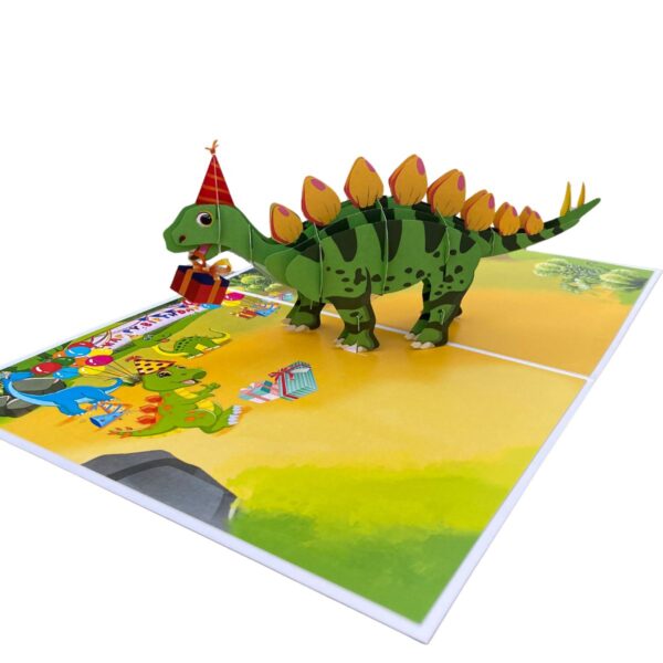 Schrägansicht der aufgeklappten 3D-Pop-up-Geburtstagskarte mit einem Stegosaurus im Partyhut und kleinen Dinosauriern