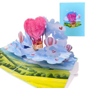 Aufgeklappte 3D-Pop-up-Liebeskarte mit einem rosa Herz-Heissluftballon über Wolken, daneben die blaue Vorderseite
