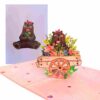 Carte Pop-Up Ours Printemps & Chariot Fleuri – photo catalogue avec carte ouverte et couverture en arrière-plan