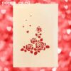 Cream cover with cascading red roses cut‑out on pop‑up wedding greeting card