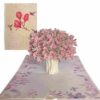 Magnolia bouquet pop‑up card displaying cover art beside lush 3‑D interior scene