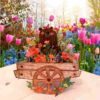 Close‑up of layered flowers and smiling bear in 3‑D spring card